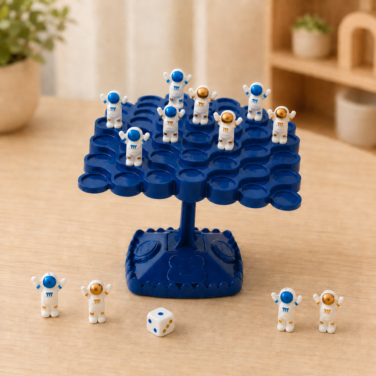 Astronauta Equilibrista: árvore azul com astronautas equilibrados, dado e peças numa mesa Equilibrista